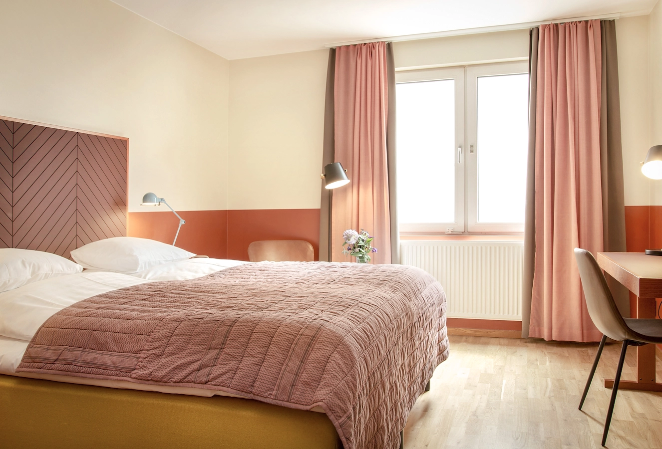 Säng i superior rum på Hotel Noble House